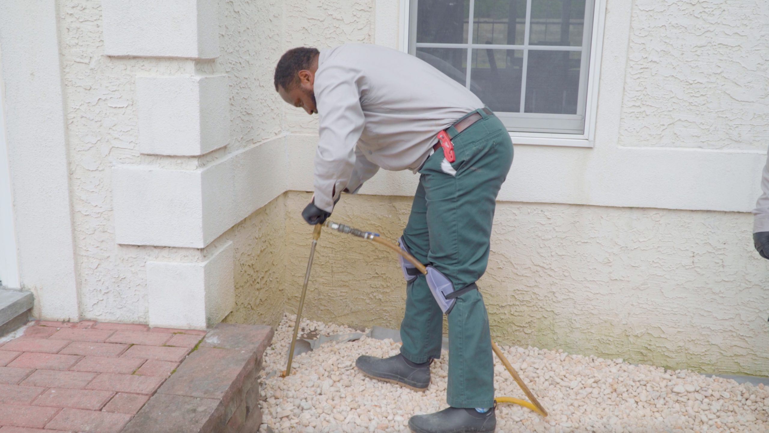 pest control technician spraying for termites