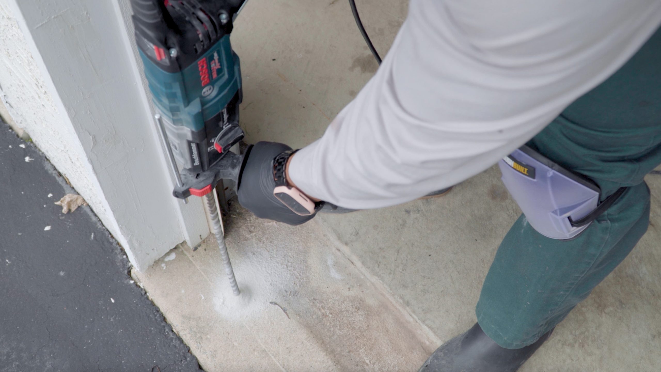 pest control technician drilling to perform termite treatment